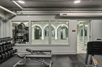 Fitness center with free weights and glass workout studio